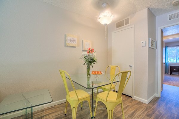 Elegant dining room with modern furnishings at Eagle Point Apartments with large windows