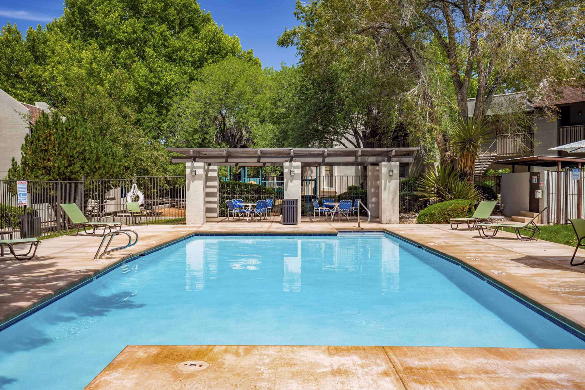 Resort-style pool with sundeck and seating at Eagle Point Apartments