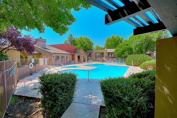 Resort-style pool with sundeck and seating at Eagle Point Apartments