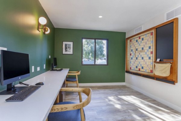 Modern business center with workstations and conference table at Avana Tempe Apartments