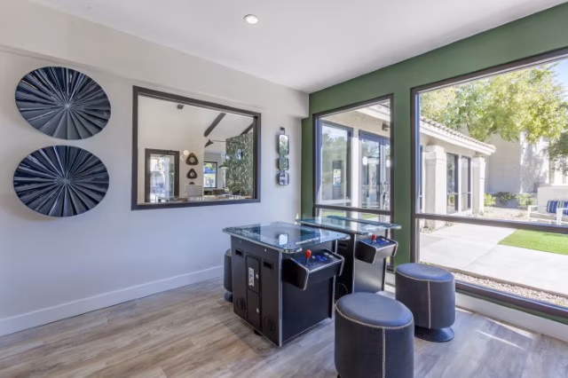 Game room featuring pool tables and plush seating at Avana Tempe Apartments