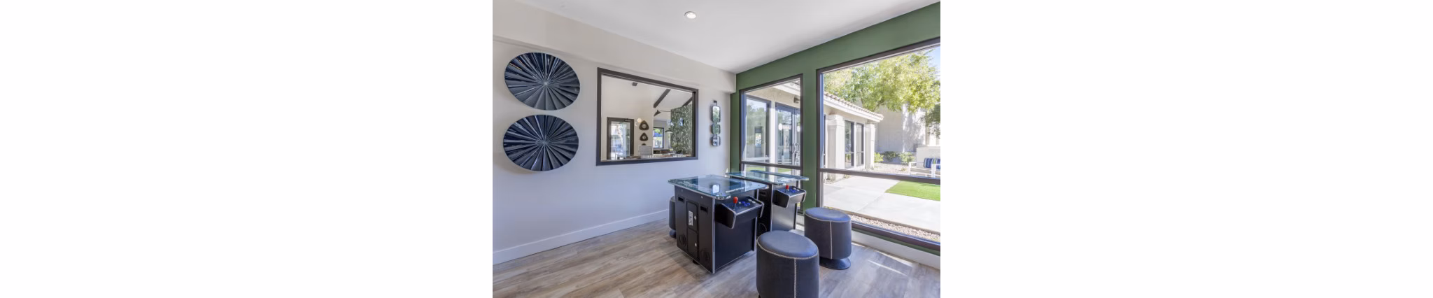 Game room featuring pool tables and plush seating at Avana Tempe Apartments