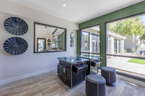 Game room featuring pool tables and plush seating at Avana Tempe Apartments