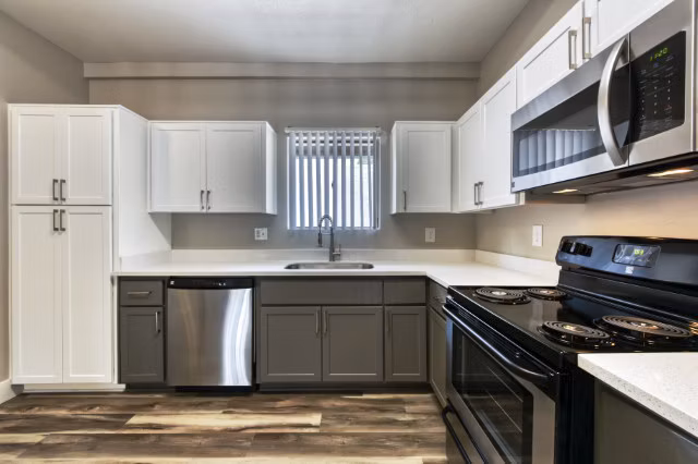 Contemporary kitchen with stainless steel appliances at Avana Tempe Apartments