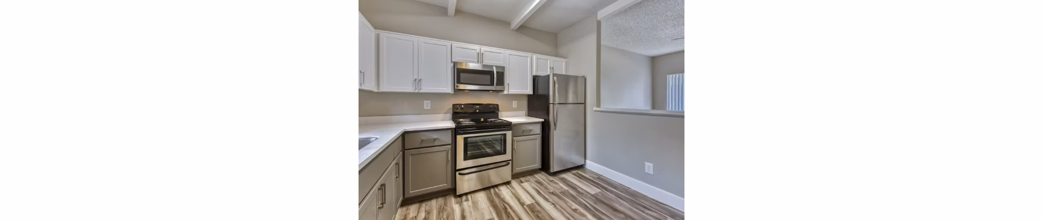 Modern kitchen with stainless steel appliances and granite countertops at Avana Tempe luxury apartments