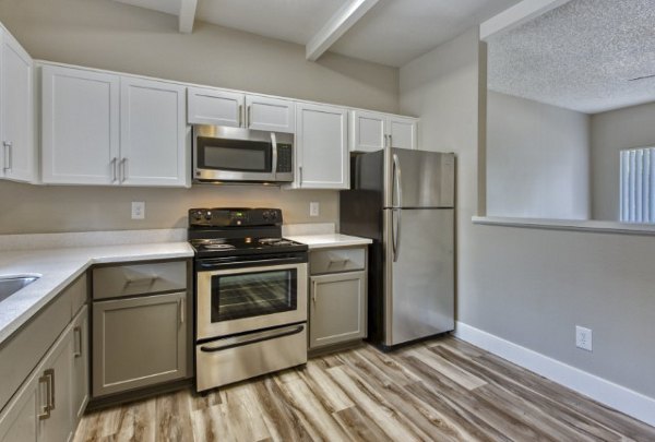 Modern kitchen with stainless steel appliances and granite countertops at Avana Tempe luxury apartments