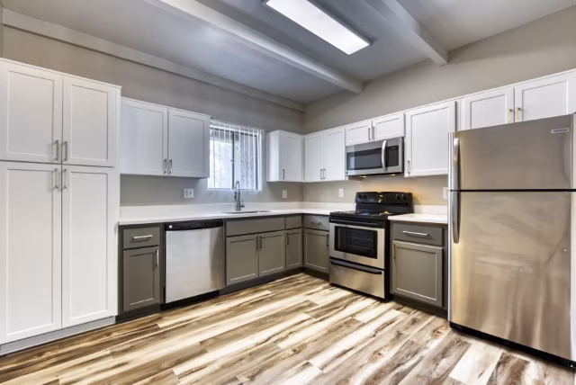 Spacious kitchen with modern appliances and granite countertops at Avana Tempe Apartments
