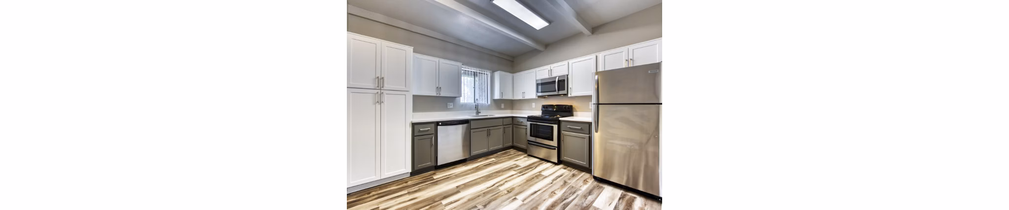 Spacious kitchen with modern appliances and granite countertops at Avana Tempe Apartments