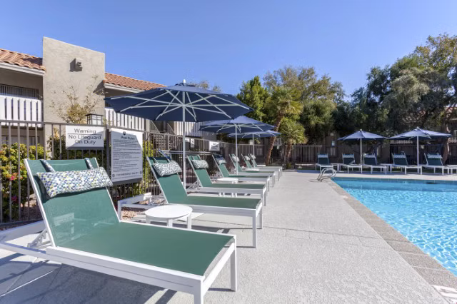 Resort-style pool area with lounge seating at Avana Tempe Apartments, offering luxury living amenities