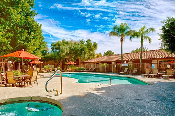 Luxurious outdoor pool with lounge chairs at Flagstone Apartments, a Greystar luxury property