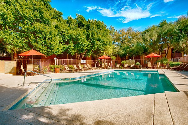 Resort-style pool with lounge seating at Flagstone Apartments in luxury Greystar community