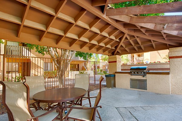 Grill area with modern barbeque stations at Flagstone Apartments, a Greystar luxury community