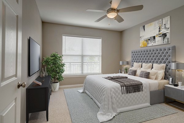 Elegant bedroom with chic decor and ample natural light in Boardwalk at Town Center Apartments
