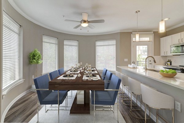 Dining area featuring modern furniture and elegant lighting at Boardwalk at Town Center Apartments