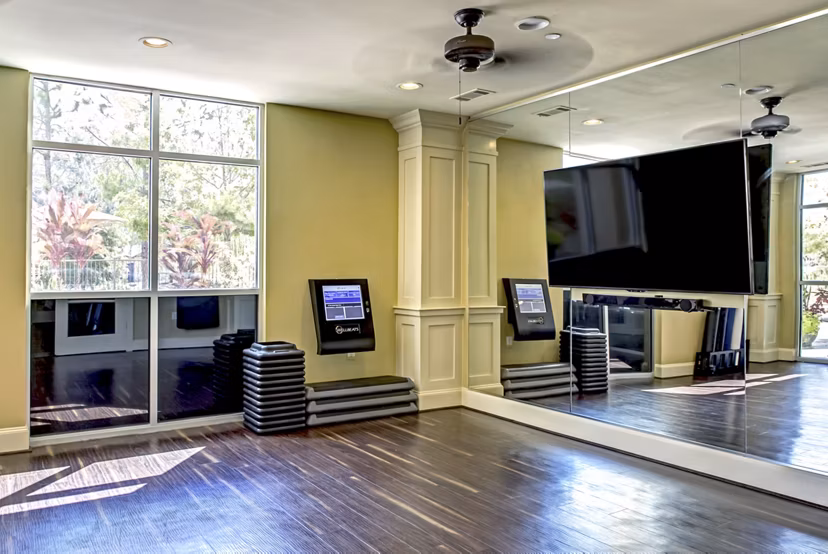 State-of-the-art fitness center at Boardwalk at Town Center Apartments offering modern equipment and spacious workout area