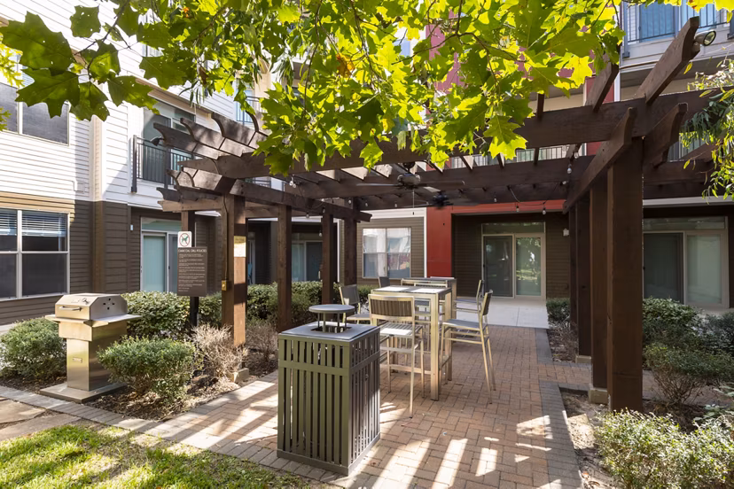 Outdoor grilling area with modern BBQ facilities at Boardwalk at Town Center Apartments, ideal for gatherings and entertainment
