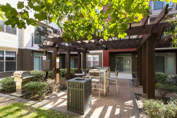 Outdoor grilling area with modern BBQ facilities at Boardwalk at Town Center Apartments, ideal for gatherings and entertainment