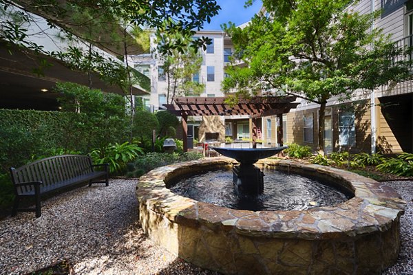 Boardwalk at Town Center: Inviting courtyard with landscaped greenery at luxury apartments in The Woodlands