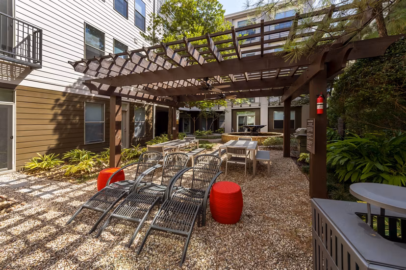 Outdoor patio with cozy seating and string lights at Boardwalk at Town Center Apartments, perfect for relaxation and gatherings