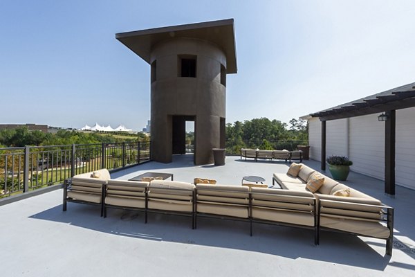 Rooftop deck with lounge seating and stunning views at Boardwalk at Town Center Apartments