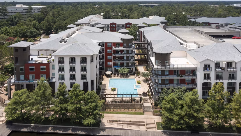 Boardwalk at Town Center: Scenic view of luxury apartments surrounded by lush greenery, appealing to those seeking refined living experiences