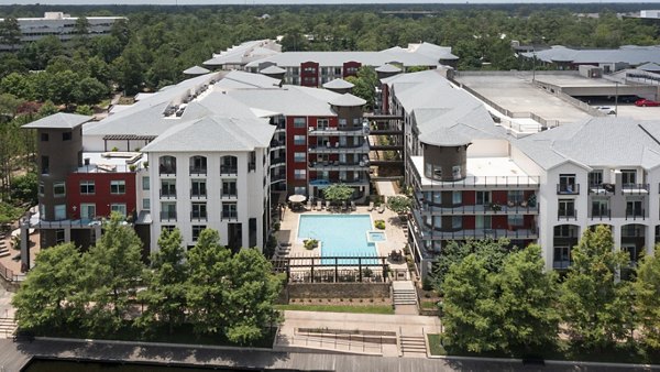 Boardwalk at Town Center: Scenic view of luxury apartments surrounded by lush greenery, appealing to those seeking refined living experiences