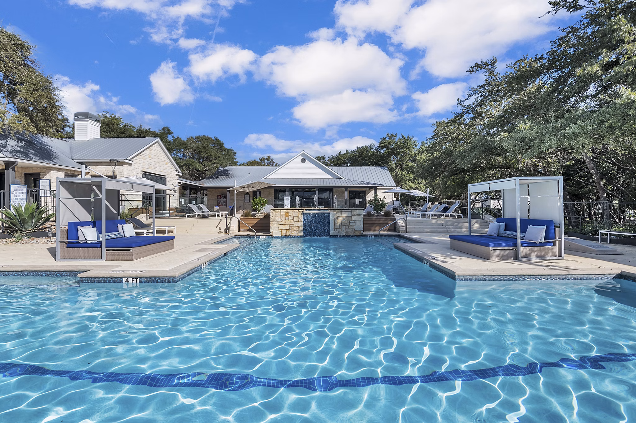 Resort-style pool with lounge seating at The Preserve at Travis Creek Apartments, luxury living in a serene Austin setting