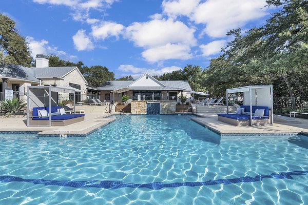 Resort-style pool with lounge seating at The Preserve at Travis Creek Apartments, luxury living in a serene Austin setting
