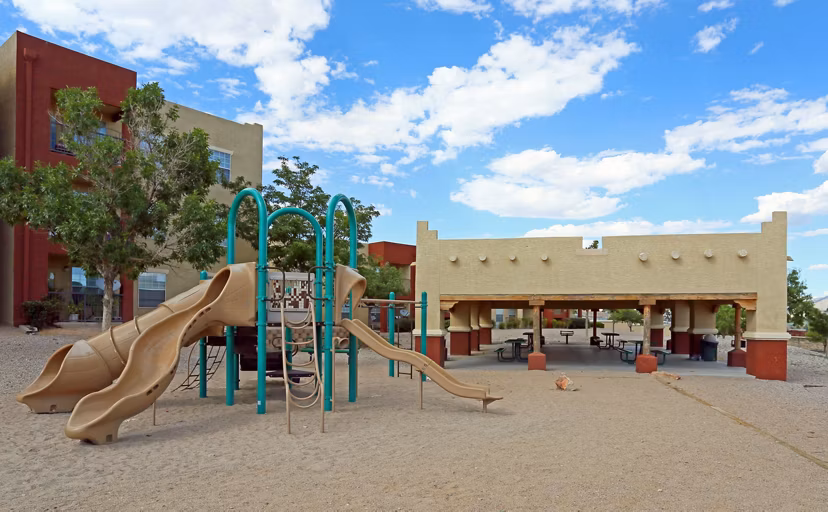Outdoor playground at Odyssey Landing Apartments featuring modern play equipment for family-friendly recreation spaces