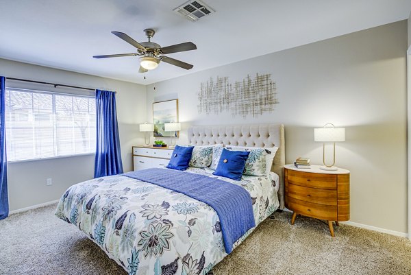 Cozy bedroom with modern decor at Destinations Alexander Apartments