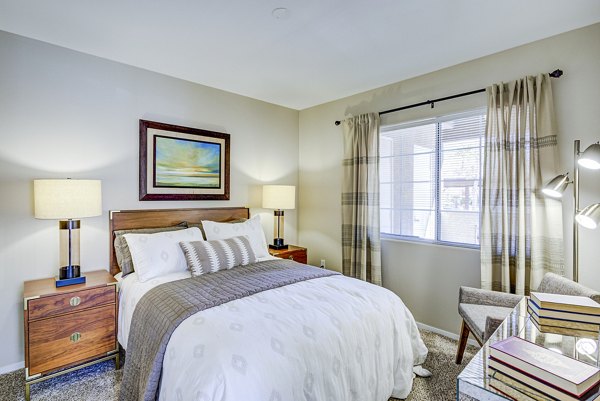 Cozy bedroom with plush carpeting at Destinations Alexander Apartments