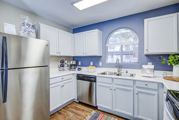 Modern kitchen with stainless steel appliances at Destinations Alexander Apartments