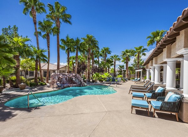 Resort-style pool with palm trees at Destinations Alexander Apartments perfect for relaxation and leisure activities