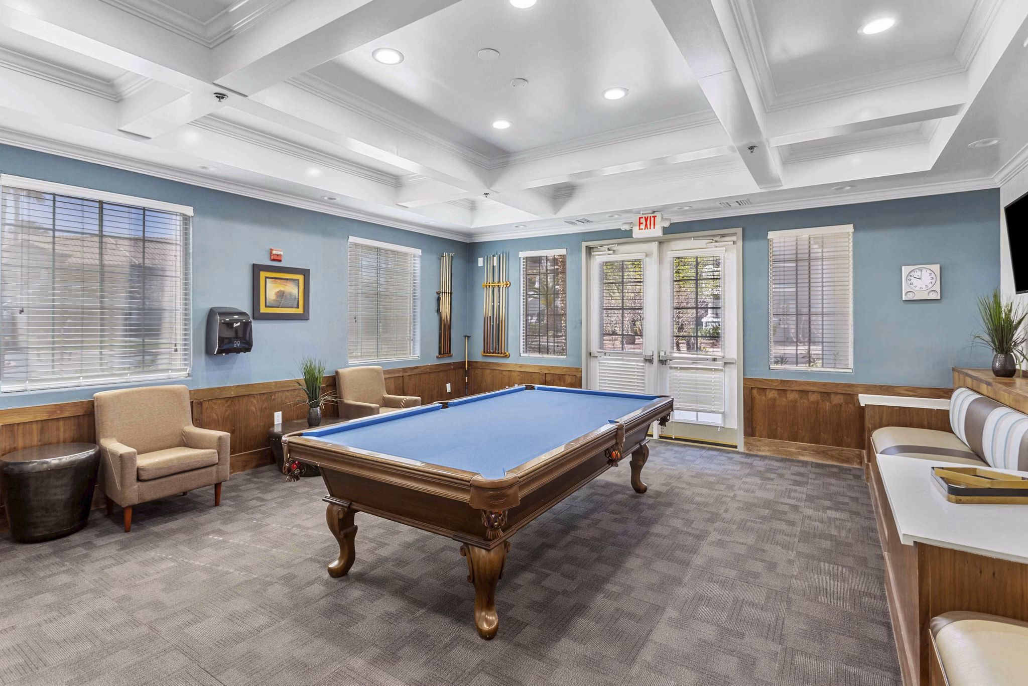 Vibrant game room with pool table and arcade games at Destinations Pebble Apartments, offering leisure and fun for residents