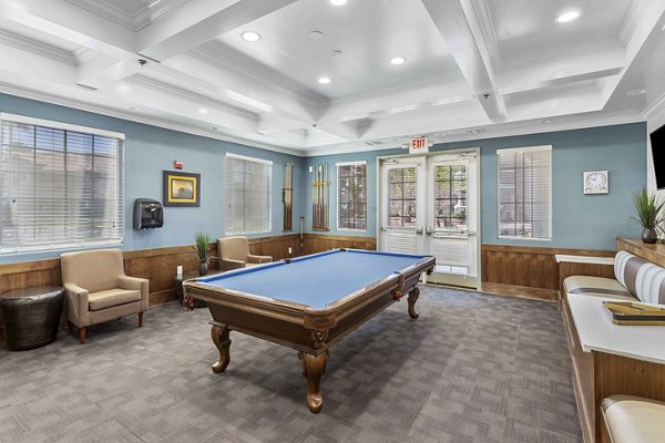 Vibrant game room with pool table and arcade games at Destinations Pebble Apartments, offering leisure and fun for residents