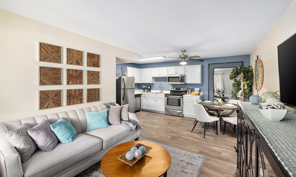 Modern living room with sleek furniture and large windows at Destinations Pebble Apartments, luxury living in vibrant community