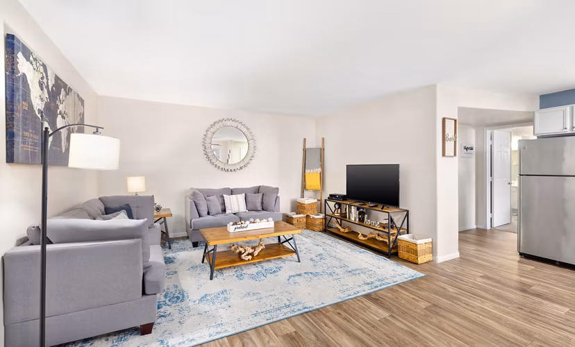 Spacious living room with modern decor in Destinations Pebble Apartments