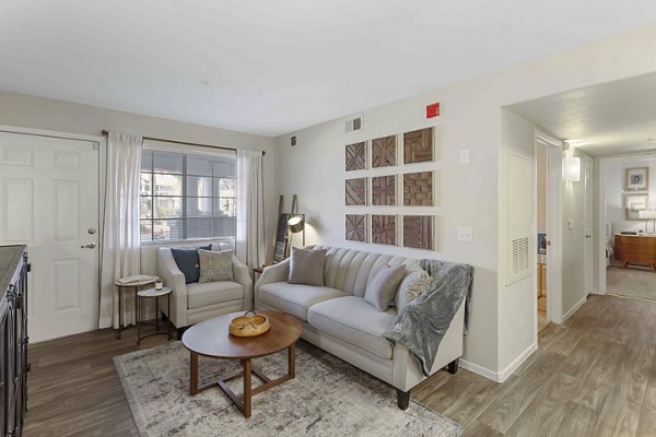 Spacious living room with modern decor in Destinations Pebble Apartments