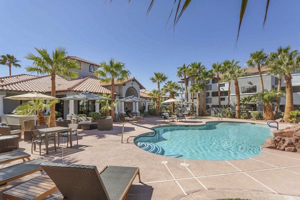 Resort-style pool with sun loungers at Destinations Pebble Apartments, offering luxury living