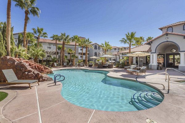 Pool with resort-style lounge chairs at Destinations Pebble Apartments, offering luxurious relaxation