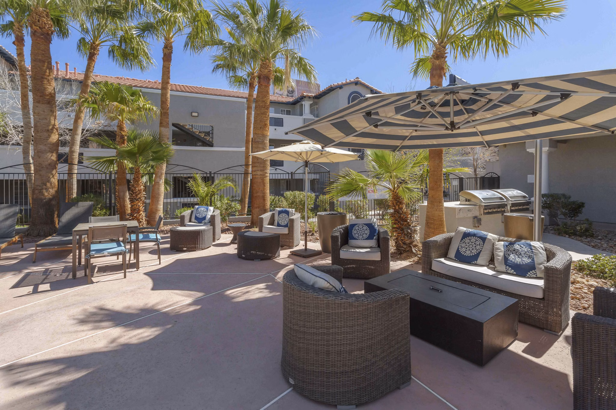 Cozy fire pit surrounded by seating at Destinations Pebble Apartments, ideal for outdoor gatherings in a luxury setting