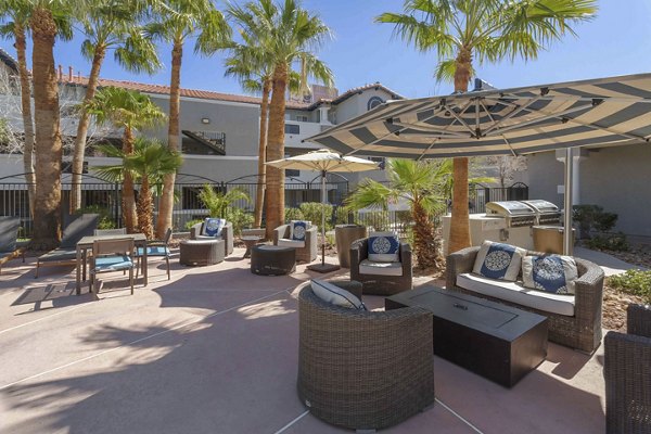 Cozy fire pit surrounded by seating at Destinations Pebble Apartments, ideal for outdoor gatherings in a luxury setting
