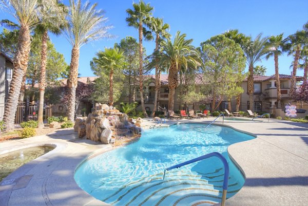 Resort-style pool with sun loungers at Destinations Pueblo Apartments, a luxury Greystar property