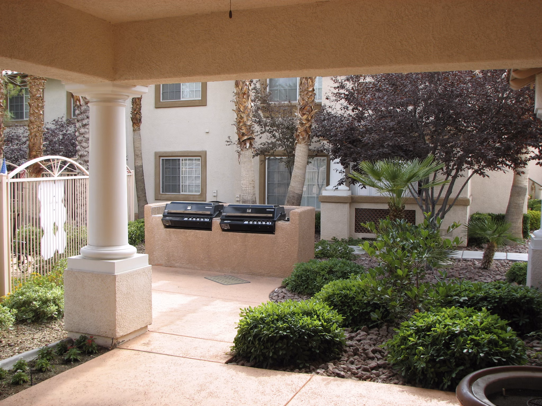 Outdoor grill area with modern seating at Destinations Pueblo Apartments, ideal for social gatherings and dining al fresco