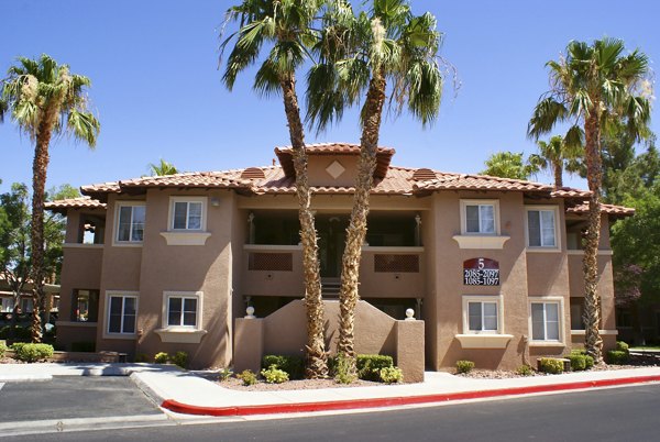 Luxury apartments with palm trees in front in a sunny location