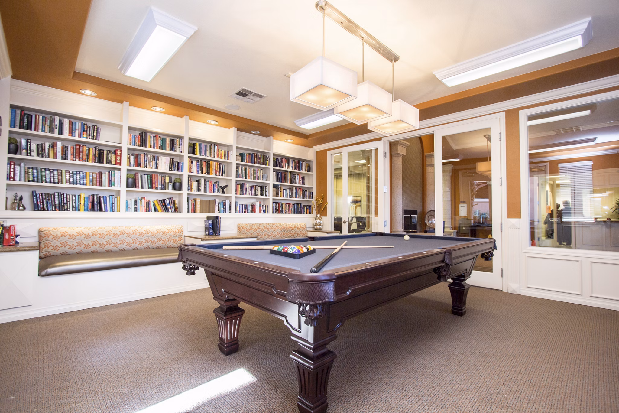 Game room with billiards and seating at Destinations Spring Valley Apartments