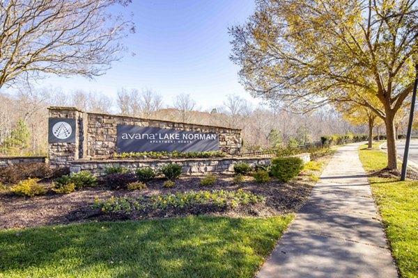 Avana Lake Norman Apartments: Modern signage amidst lush landscapes