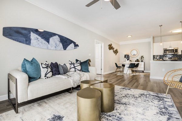 Spacious living room with modern furniture in Avana Lake Norman Apartments, featuring natural light and open layout