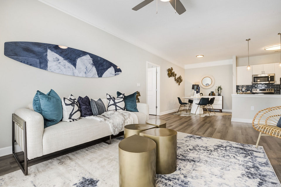 Spacious living room with modern furniture in Avana Lake Norman Apartments, featuring natural light and open layout