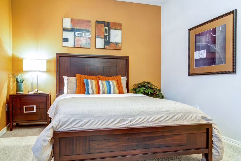 Cozy bedroom with modern decor in Estates at Memorial Heights Apartments, featuring ample natural light and stylish furnishings